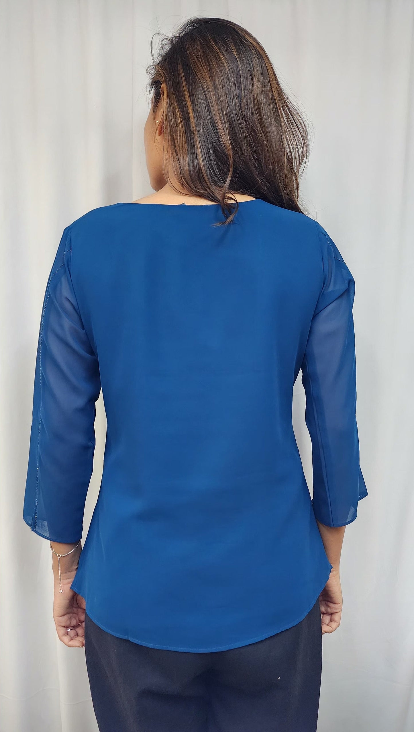 WOMENS SOLID TOP WITH DIAMOND EMBELLISHMENT IN BLUE. ROUND NECK, 3/4TH SLEEVES WITH SLIT ON FRONT & SLEEVES.