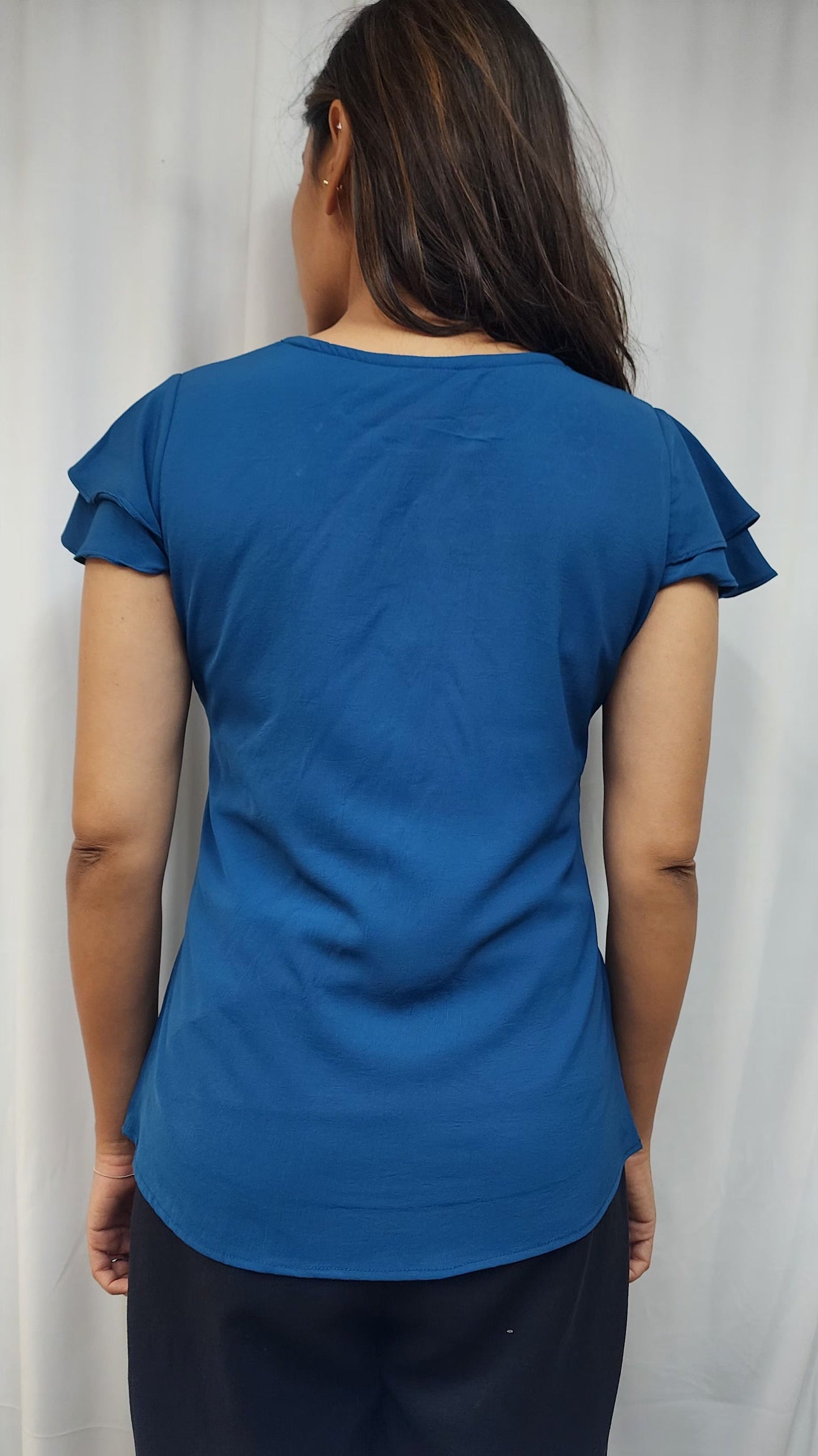 WOMENS SOLID TOP WITH DIAMOND EMBELLISHMENT. ROUND NECK, LAYERED RUFFLE SLEEVES.