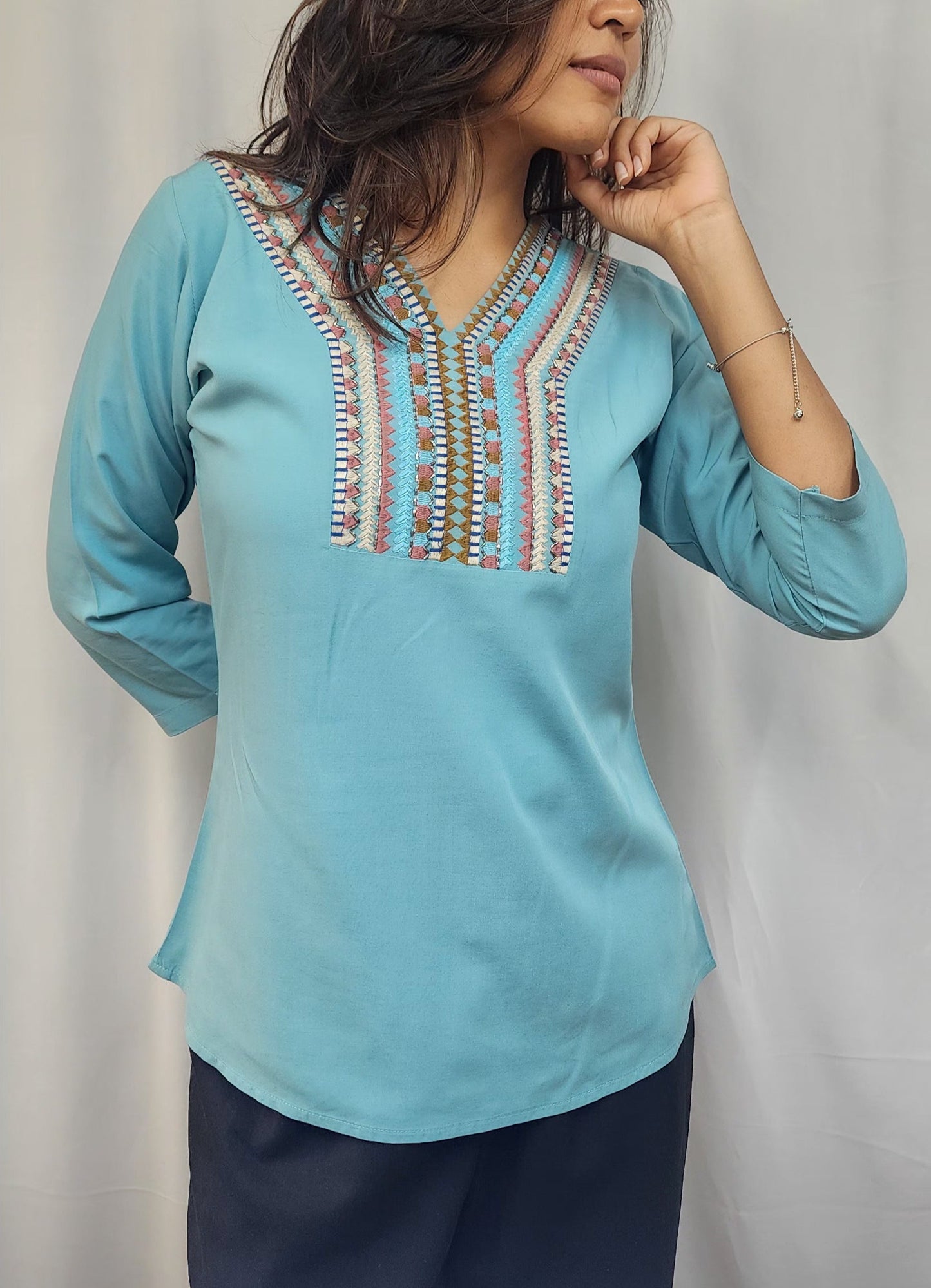 WOMENS SOLID EMBROIDERED TOP IN BLUE WITH V NECK, 3/4 TH SLEEVES, COLOURFUL GEOMETRIC EMBROIDERY ON THE YOKE