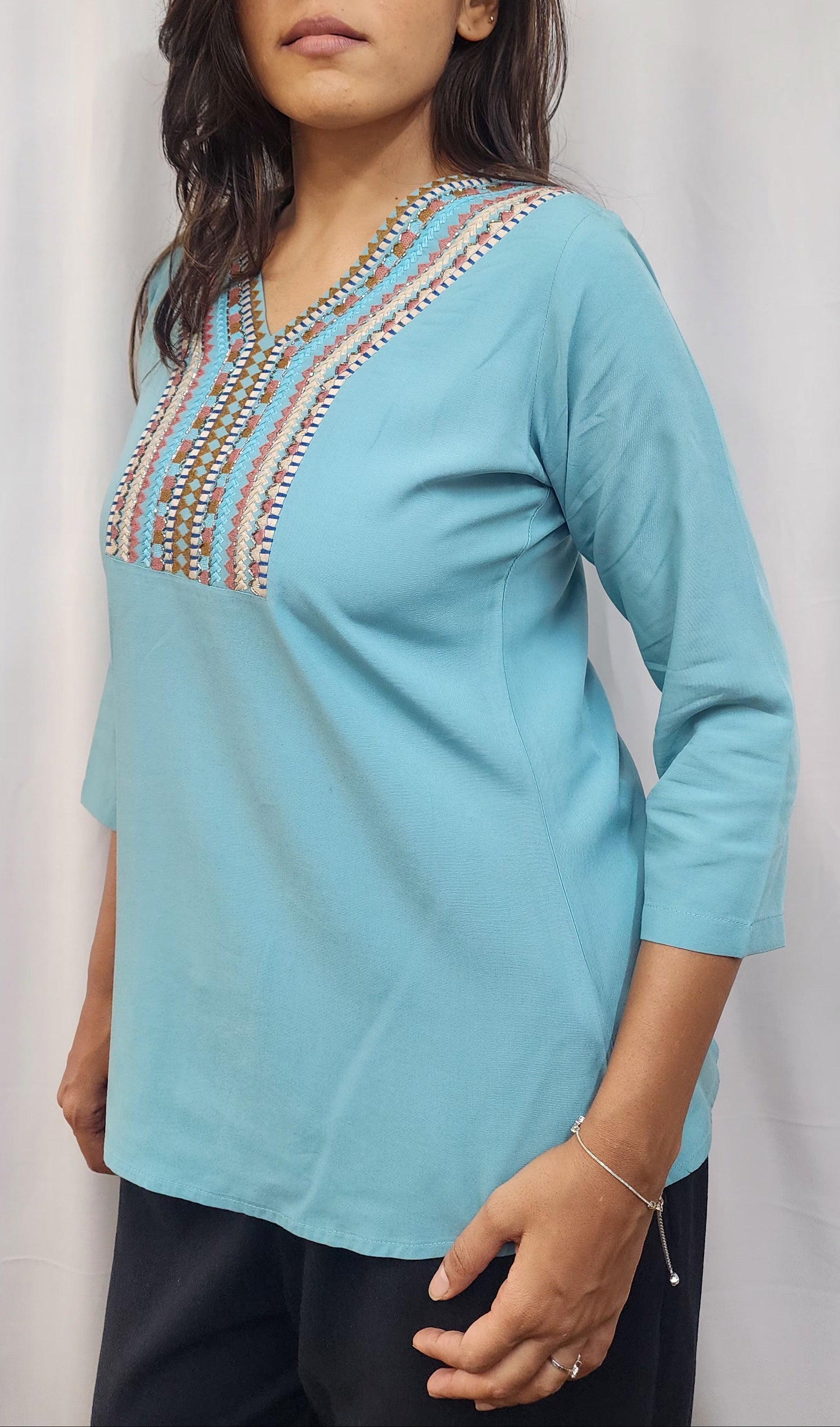 WOMENS SOLID EMBROIDERED TOP IN BLUE WITH V NECK, 3/4 TH SLEEVES, COLOURFUL GEOMETRIC EMBROIDERY ON THE YOKE