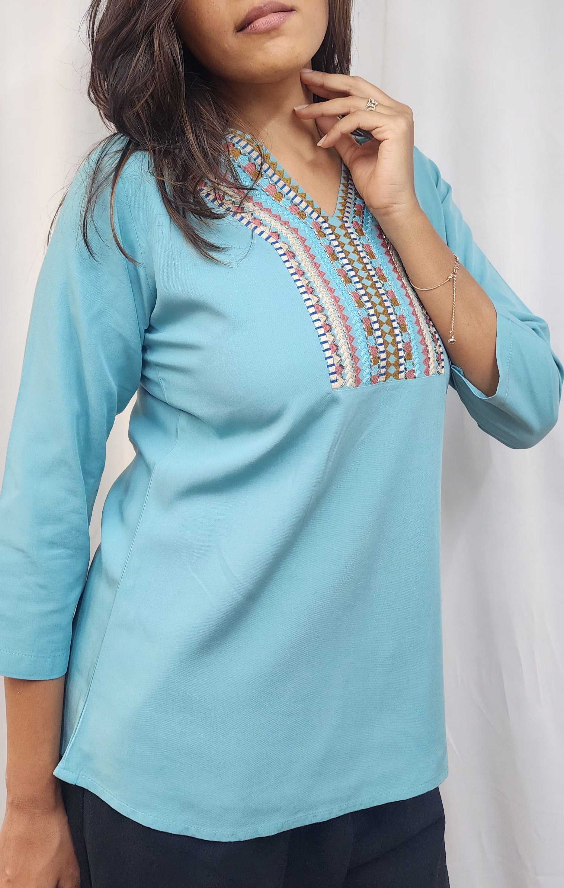 WOMENS SOLID EMBROIDERED TOP IN BLUE WITH V NECK, 3/4 TH SLEEVES, COLOURFUL GEOMETRIC EMBROIDERY ON THE YOKE