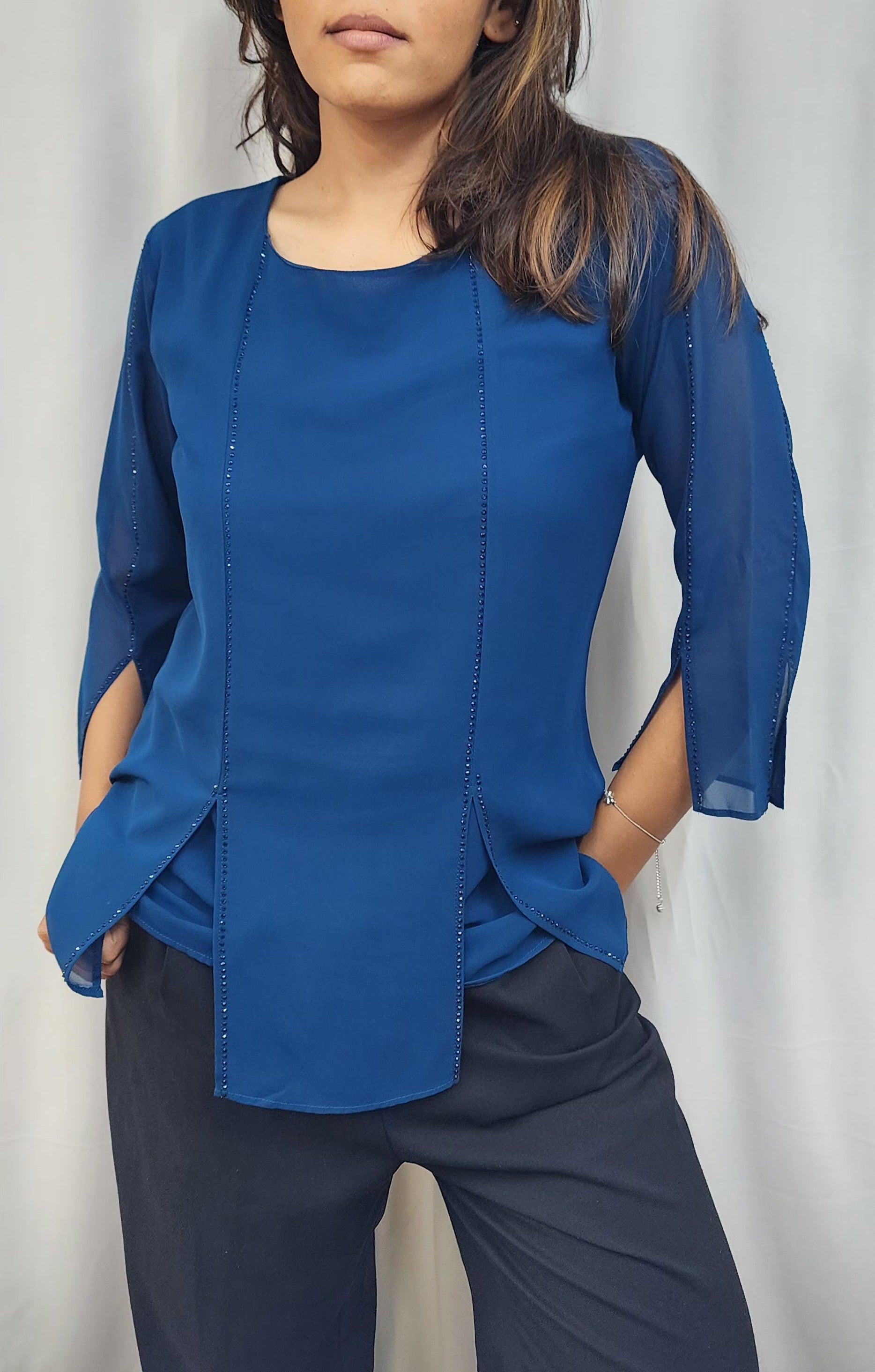 WOMENS SOLID TOP WITH DIAMOND EMBELLISHMENT IN BLUE. ROUND NECK, 3/4TH SLEEVES WITH SLIT ON FRONT & SLEEVES.
