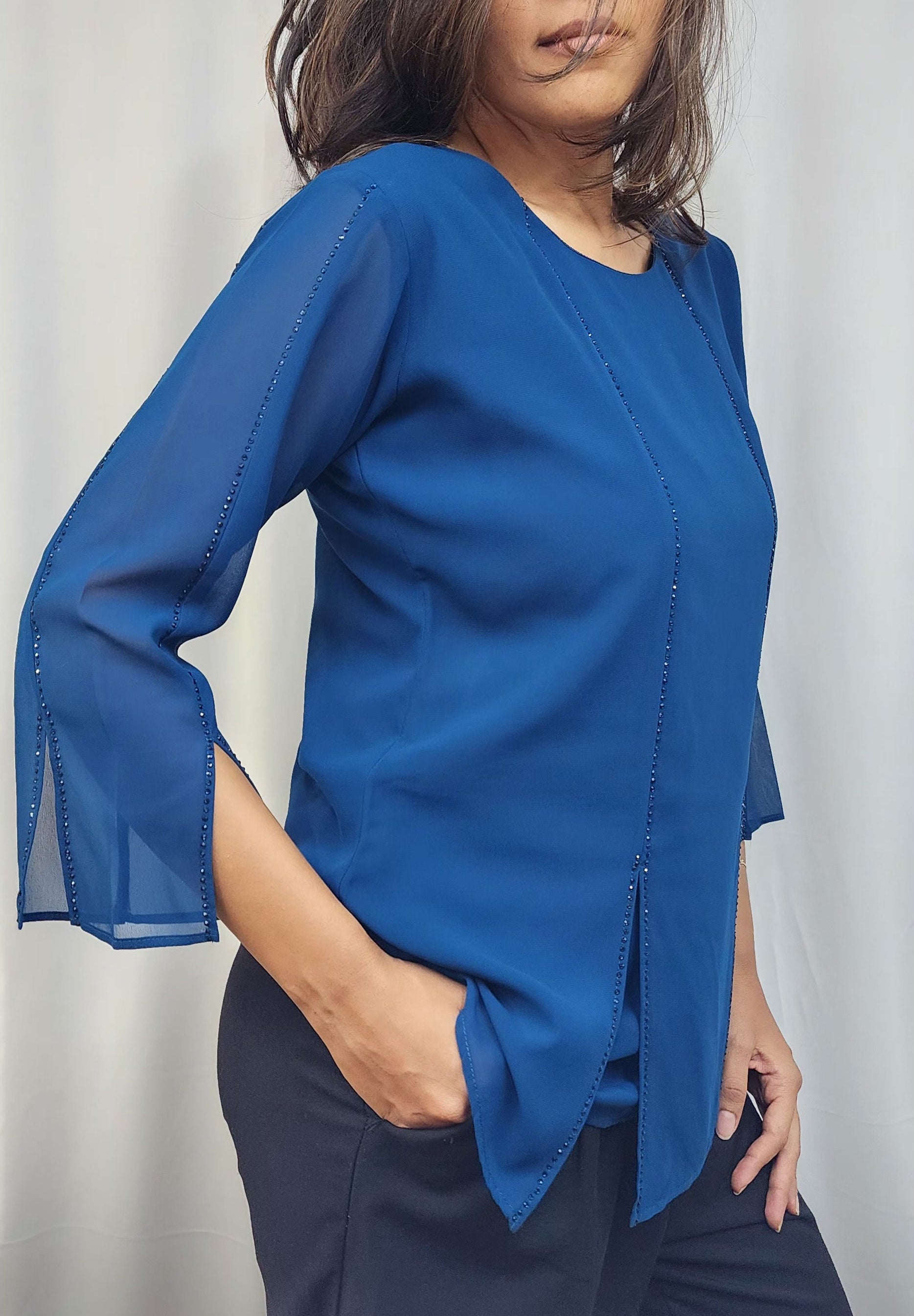 WOMENS SOLID TOP WITH DIAMOND EMBELLISHMENT IN BLUE. ROUND NECK, 3/4TH SLEEVES WITH SLIT ON FRONT & SLEEVES.