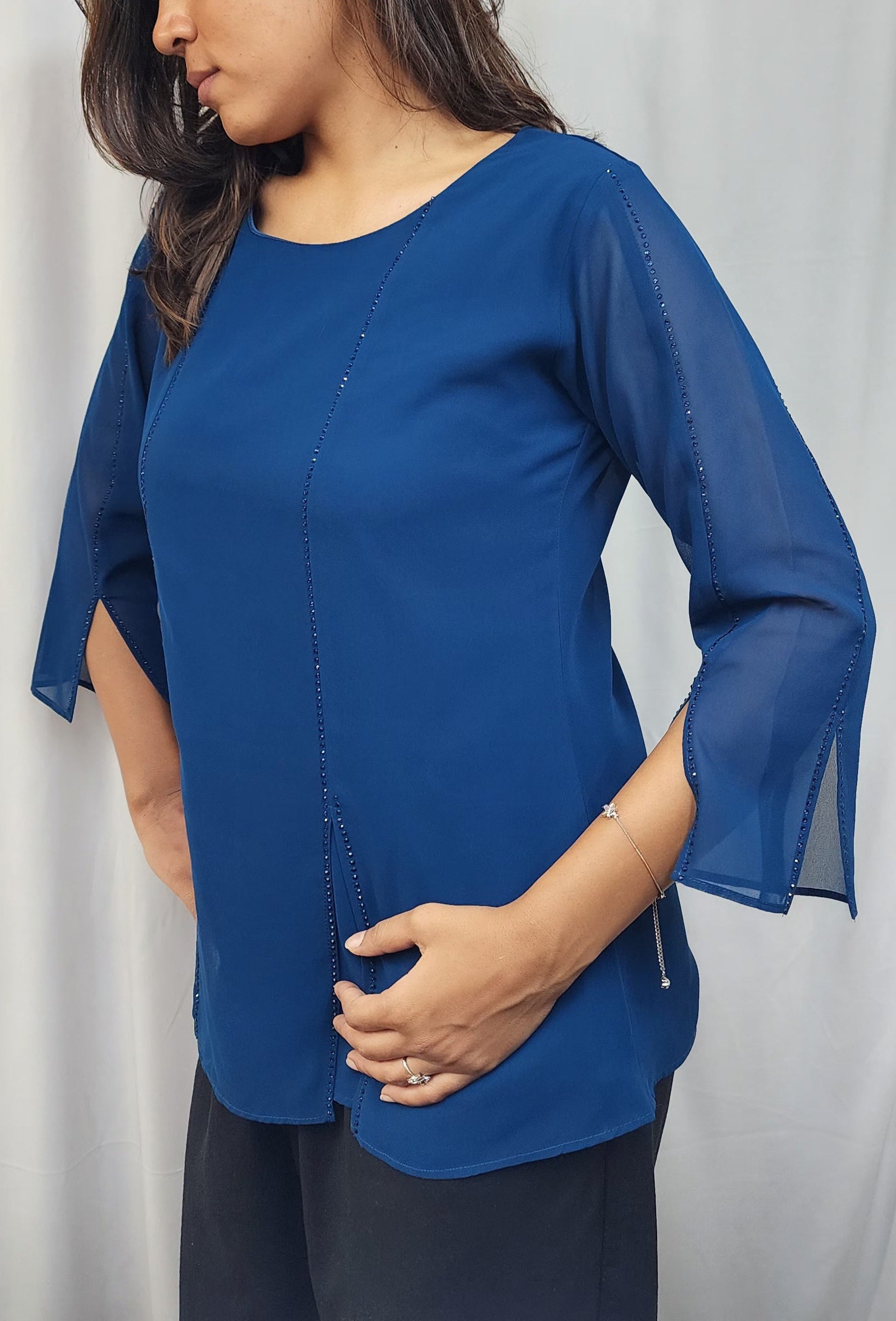 WOMENS SOLID TOP WITH DIAMOND EMBELLISHMENT IN BLUE. ROUND NECK, 3/4TH SLEEVES WITH SLIT ON FRONT & SLEEVES.