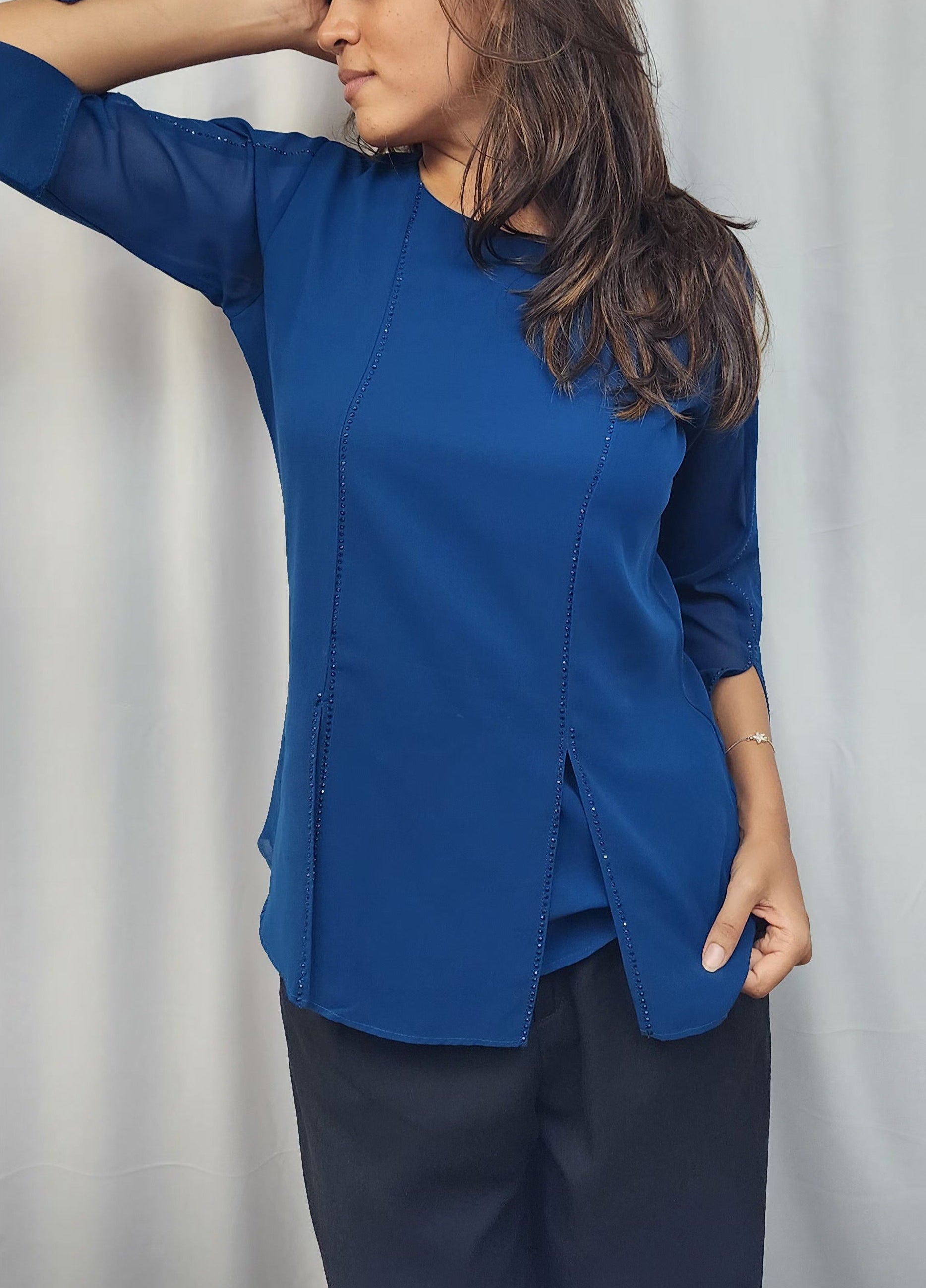 WOMENS SOLID TOP WITH DIAMOND EMBELLISHMENT IN BLUE. ROUND NECK, 3/4TH SLEEVES WITH SLIT ON FRONT & SLEEVES.