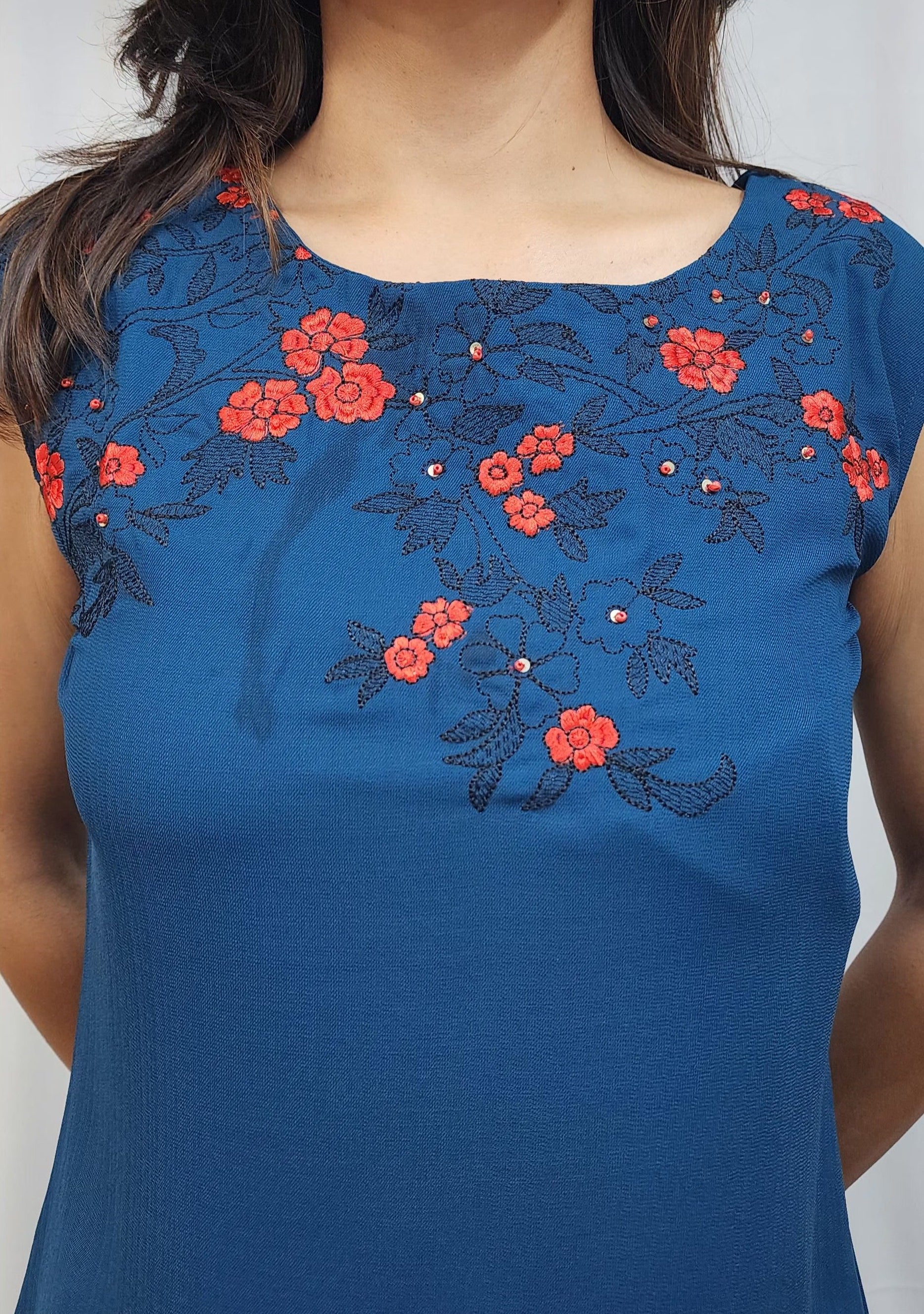 WOMENS SOLID TOP WITH FLORAL EMBROIDERY. SLEEVELESS ROUND NECK TOP