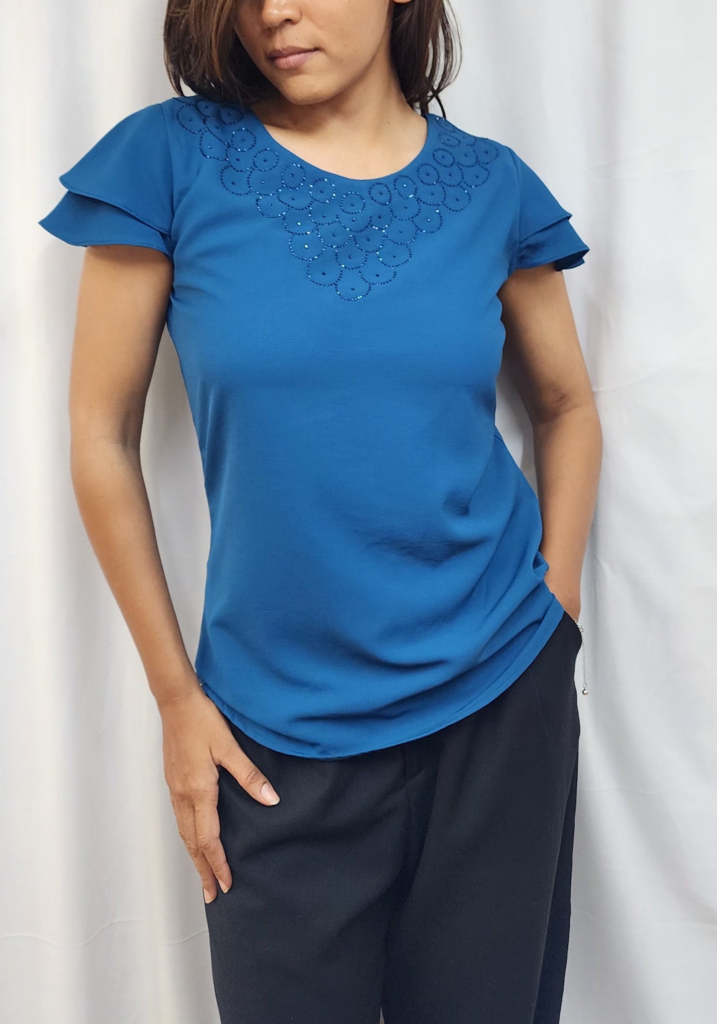 WOMENS SOLID TOP WITH DIAMOND EMBELLISHMENT. ROUND NECK, LAYERED RUFFLE SLEEVES.