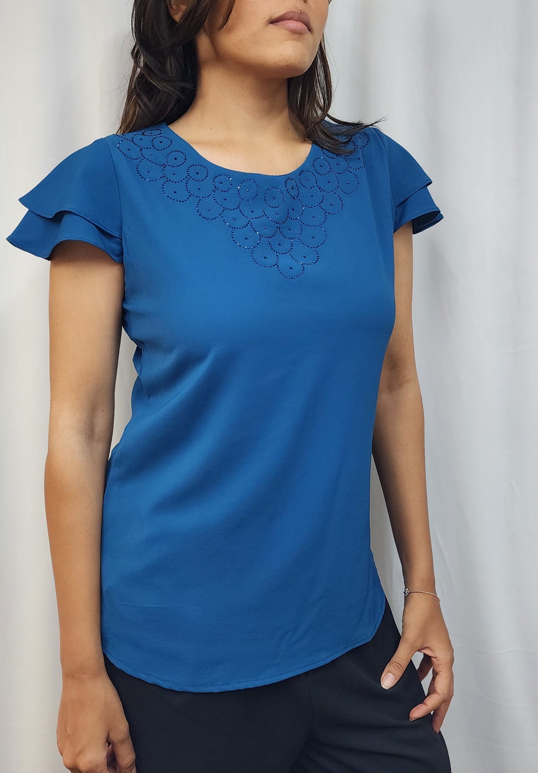 WOMENS SOLID TOP WITH DIAMOND EMBELLISHMENT. ROUND NECK, LAYERED RUFFLE SLEEVES.